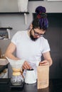 Hipster barista man brewing chemex alternative coffee