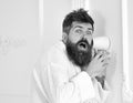 Hipster in bathrobe on shocked face secretly listen conversation. Secret and spy concept. Man with beard and mustache