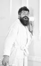 Hipster in bathrobe on surprised face secretly listen conversation. Secret and spy concept. Man with beard and mustache