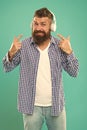 Hipster with beard listening music. Handsome music lover. Man in headphones. Streaming sites which we believe are Royalty Free Stock Photo