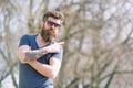 Hipster with beard looks stylish on sunny day. Man with beard and mustache on strict face pointing, nature background Royalty Free Stock Photo