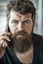 Hipster bearded communicate smartphone call. Mobile communication. Communication concept. Man with beard and mustache Royalty Free Stock Photo