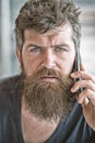 Hipster bearded communicate smartphone call. Mobile communication. Communication concept. Man with beard and mustache Royalty Free Stock Photo