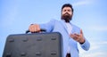 Hipster bearded face hold briefcase with bribe. Business man formal suit carries briefcase sky background. Businessman