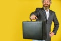 Hipster bearded face hold briefcase with bribe. Businessman run away business case. Happy smiling worker. Business man