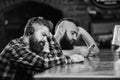 Hipster bearded man spend leisure at bar counter. Order drinks at bar counter. Men with headphones and smartphone Royalty Free Stock Photo