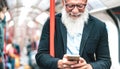 Hipster bearded man using mobile smart phone in subway train - Trendy adult person checking timetable with smartphone Royalty Free Stock Photo