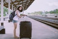 Hipster beautiful asian woman waiting train at train station,Happy and smiling,Travel and vacation concept Royalty Free Stock Photo