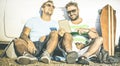 Hipster best friends having fun with tablet at car trip moment Royalty Free Stock Photo