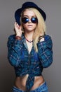 Hipster blond girl in hat and sunglasses Royalty Free Stock Photo