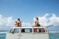 Hipster boy playing guitar with girlfriend on top of retro style Royalty Free Stock Photo