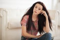 Hipster Woman sitting near white leather sofa