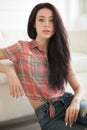 Hipster Woman sitting near white leather sofa