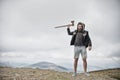 Hipster brutal bearded man with axe stand on mountain top Royalty Free Stock Photo