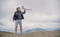 Hipster brutal bearded man with axe stand on mountain top Royalty Free Stock Photo
