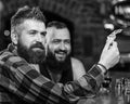 Hipster brutal bearded man spend leisure with friend at bar counter. Men relaxing at bar. Friendship and leisure. Friday Royalty Free Stock Photo