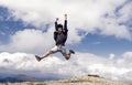 Hipster or brutal macho conquers mountain. Man with brutal appearance jumps. Freedom concept. Man with beard enjoy Royalty Free Stock Photo