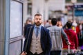 Hipster businessman in blue suit at the staition walking Royalty Free Stock Photo