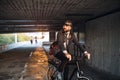 Hipster businessman commuter with electric bicycle traveling to work in city. Royalty Free Stock Photo