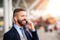 Hipster businessman making phone call waiting at the airport Royalty Free Stock Photo
