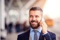 Hipster businessman making phone call waiting at the airport Royalty Free Stock Photo