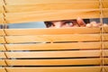 Hipster businessman peeking through blinds Royalty Free Stock Photo