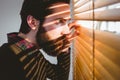 Hipster businessman peeking through blinds Royalty Free Stock Photo