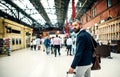 Hipster businessman with suitcase walking inside subway station in London. Royalty Free Stock Photo