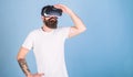 Hipster on busy face exploring virtual reality with gadget. Interactive surface concept. Guy with head mounted display Royalty Free Stock Photo