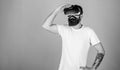 Hipster on busy face exploring virtual reality with gadget. Interactive surface concept. Guy with head mounted display Royalty Free Stock Photo