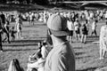 Hipster in cap happy celebrate event fest or festival. Summer fest. Man bearded hipster in front of crowd. Open air Royalty Free Stock Photo