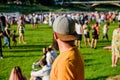 Hipster in cap happy celebrate event fest or festival. Summer fest. Man bearded hipster in front of crowd. Open air Royalty Free Stock Photo