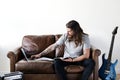 Hipster Caucasian rocker working on a laptop