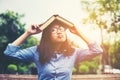 Hipster charming girl relaxing in the park while read book, Enjoy nature around Royalty Free Stock Photo