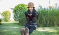 Hipster charming girl relaxing in the park while read book, Enjoy nature around Royalty Free Stock Photo