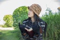 Hipster charming girl relaxing in the park while read book, Enjoy nature around Royalty Free Stock Photo