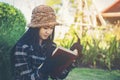 Hipster charming girl relaxing in the park while read book, Enjoy nature around Royalty Free Stock Photo