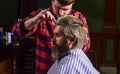 Hipster client getting haircut. Barber scissors. Manage your expectations. Cut hair. Barber making hairstyle for bearded