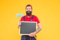 Hipster with copy space on board. repair and building. craftsman on construction. creativity. reconstruction advertising Royalty Free Stock Photo