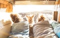 Hipster couple with cute dog traveling together on vintage van