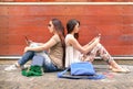 Hipster couple of girlfriends in disinterest moment with phones Royalty Free Stock Photo