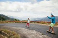 Hipster couple longboarding extremely in tropcis Royalty Free Stock Photo