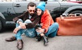 Hipster fashion couple taking selfie with mobile smartphone on roadtrip - Wanderlust concept with friends sharing photos