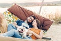 Hipster couple on a trip to the beach, young freelancer man relaxing in a hammock with his woman, romantic couple on vacation with Royalty Free Stock Photo