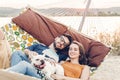 Hipster couple on a trip to the beach, young freelancer man relaxing in a hammock with his woman, romantic couple on vacation with Royalty Free Stock Photo