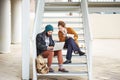 Hipster couple using computer and eating lunch outdoors Royalty Free Stock Photo