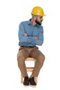 Hipster engineer sitting with folded arms and looking away careful Royalty Free Stock Photo