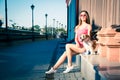 Hipster Fashion Girl and Her Dog in the City Royalty Free Stock Photo