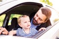 Hipster father with his little daughter in the car Royalty Free Stock Photo