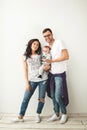 Hipster father, mother holding cute baby boy over white backgrou Royalty Free Stock Photo